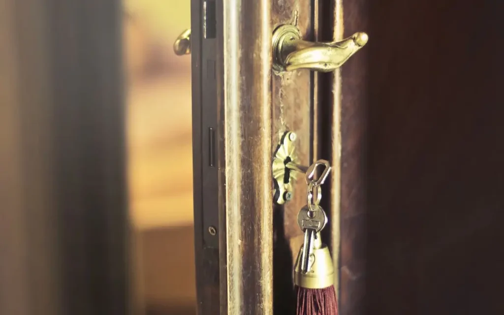 Closeup of key with tassel pendant in open weathered wooden