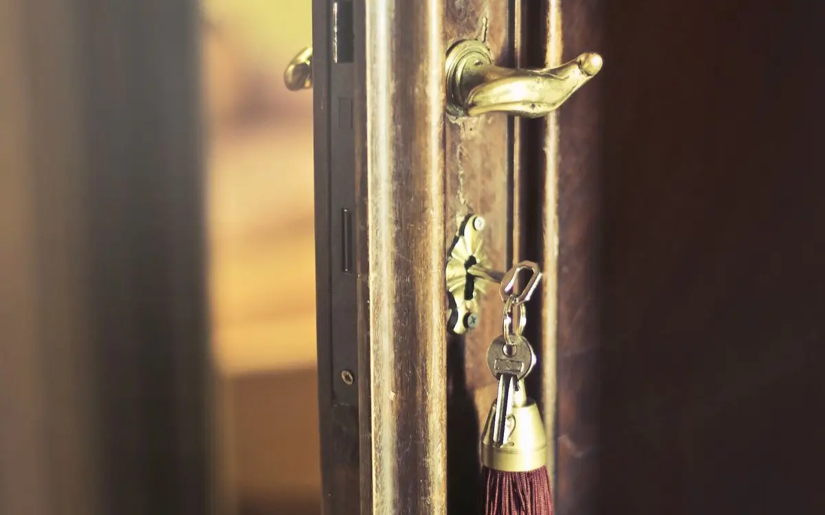 Closeup of key with tassel pendant in open weathered wooden 